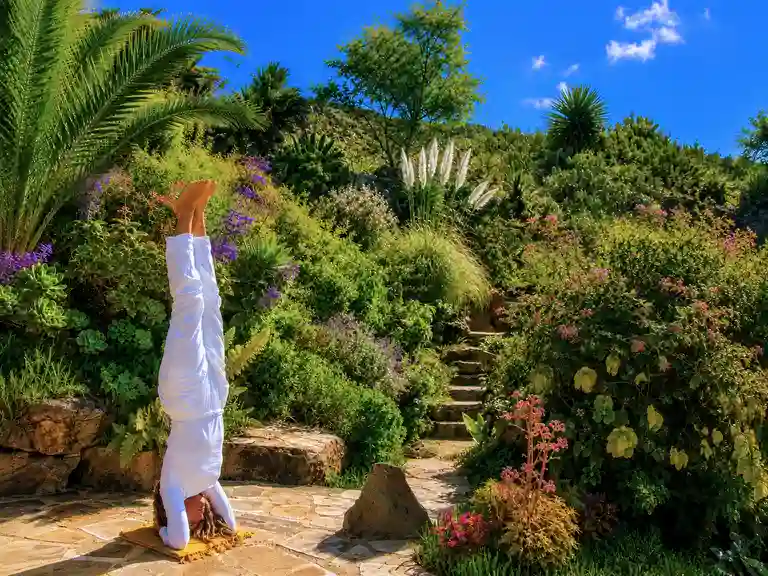 Genieße auf La Palma Yoga in einem wunderschönen Ambiente bei Vidyamor, umgeben von blühenden Pflanzen und mit weitem Blick auf den Horizont und den Himmel.